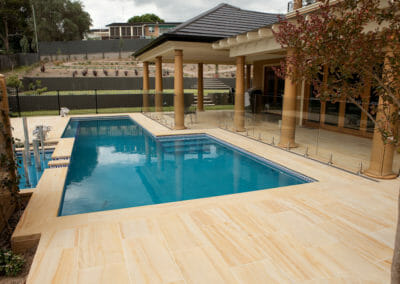 Teakwood Sandstone Pool Coping outdoors around pool