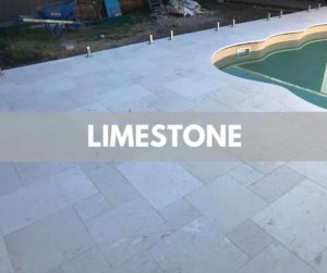 French pattern white limestone around a curved pool